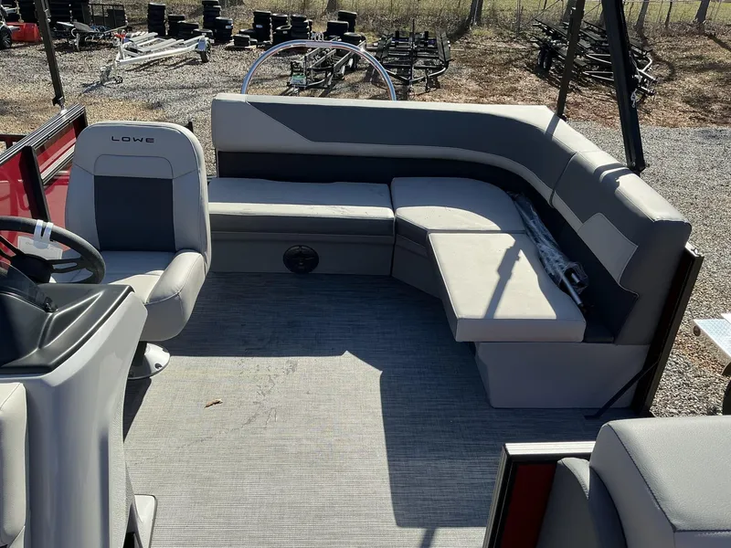 Slide: The Image of 2025 Lowe LS 170 boat interior with gray seating and steering wheel. - 8