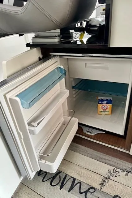Slide: The Image of Open refrigerator inside 2019 Beneteau Antares 27 boat, with Arm & Hammer baking soda. - 16