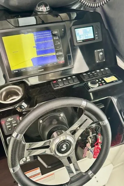 Slide: The Image of Dashboard of a 2019 Beneteau Antares 27 boat with navigation controls. - 21