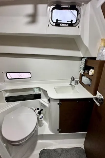 Slide: The Image of 2019 Beneteau Antares 27 bathroom with toilet, sink, and storage. - 24