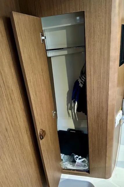 Slide: The Image of Wooden closet interior on 2019 Beneteau Antares 27 boat. - 26