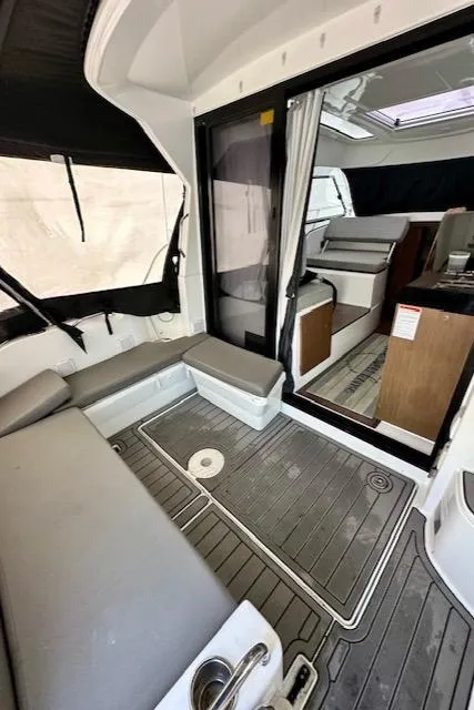 Slide: The Image of 2019 Beneteau Antares 27 interior with seating, modern design, and wood accents. - 28