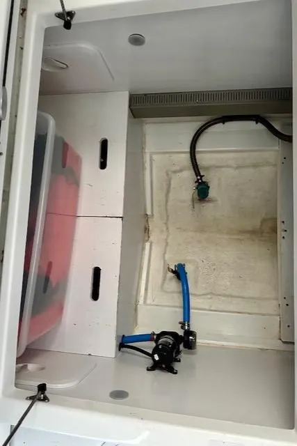 Slide: The Image of Storage compartment of a 2019 Beneteau Antares 27 boat with visible plumbing. - 32