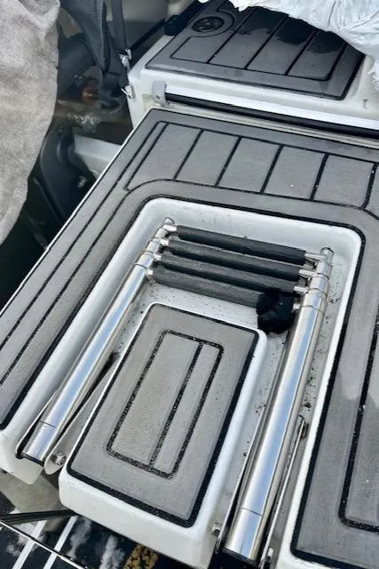 Slide: The Image of Beneteau Antares 27 (2019) boat deck with foldable ladder and storage compartments. - 34