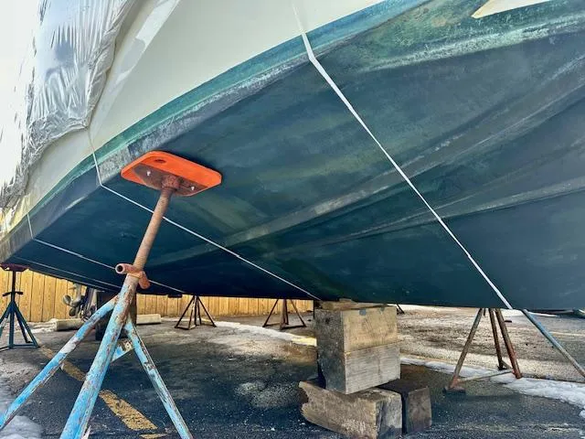 Slide: The Image of 2019 Beneteau Antares 27 boat hull on stands for maintenance. - 40