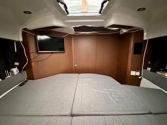 Slide: The Image of Interior cabin of 2019 Beneteau Antares 27 with bed and TV. - 6