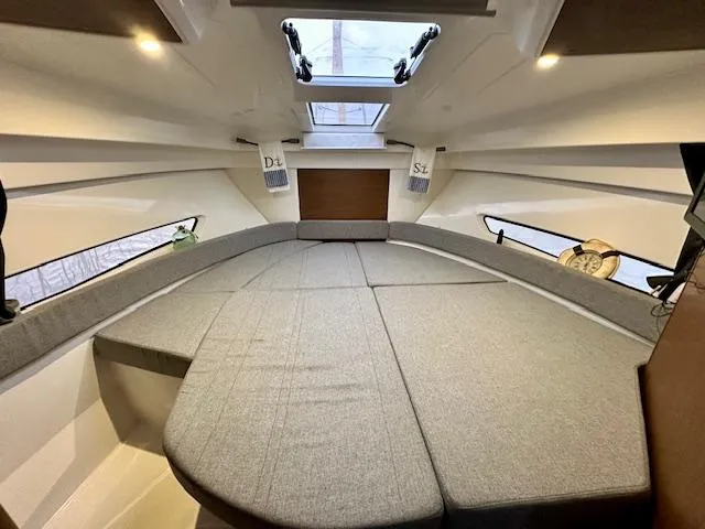 Slide: The Image of Interior cabin of 2019 Beneteau Antares 27 with skylight and cushioned seating. - 7