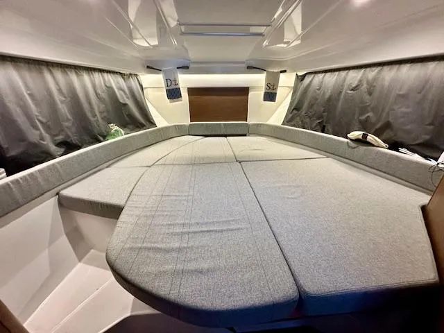 Slide: The Image of Interior cabin of 2019 Beneteau Antares 27 with spacious gray bedding. - 8