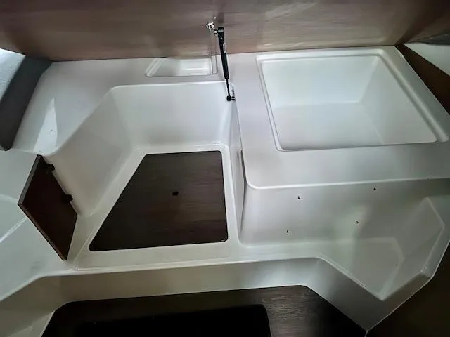 Slide: The Image of Interior view of a 2019 Beneteau Antares 27 boat, featuring a modern sink and storage area. - 9