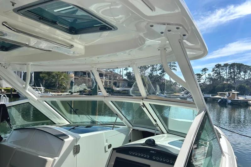 Slide: The Image of 2017 Boston Whaler 320 Vantage boat interior with scenic waterfront view. - 10