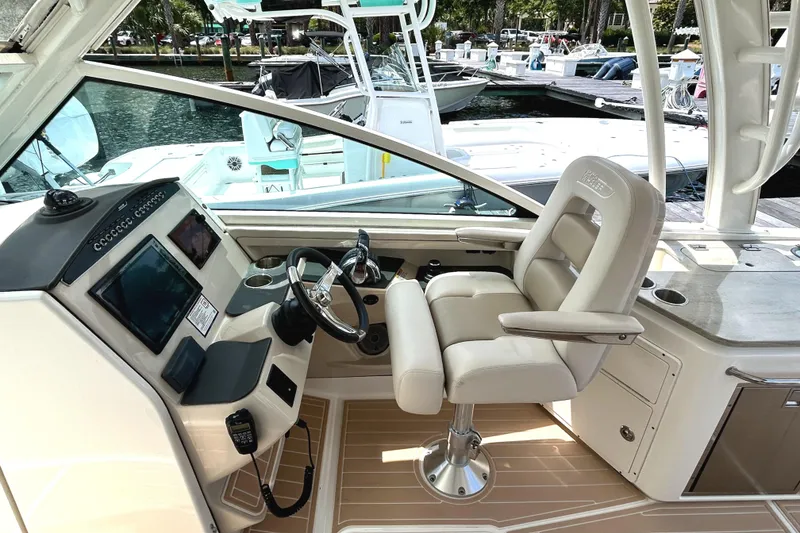 Slide: The Image of 2017 Boston Whaler 320 Vantage helm with luxurious seating and modern controls. - 11