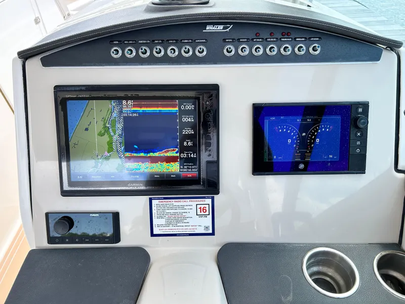 Slide: The Image of Control panel of a 2017 Boston Whaler 320 Vantage with navigation displays. - 12
