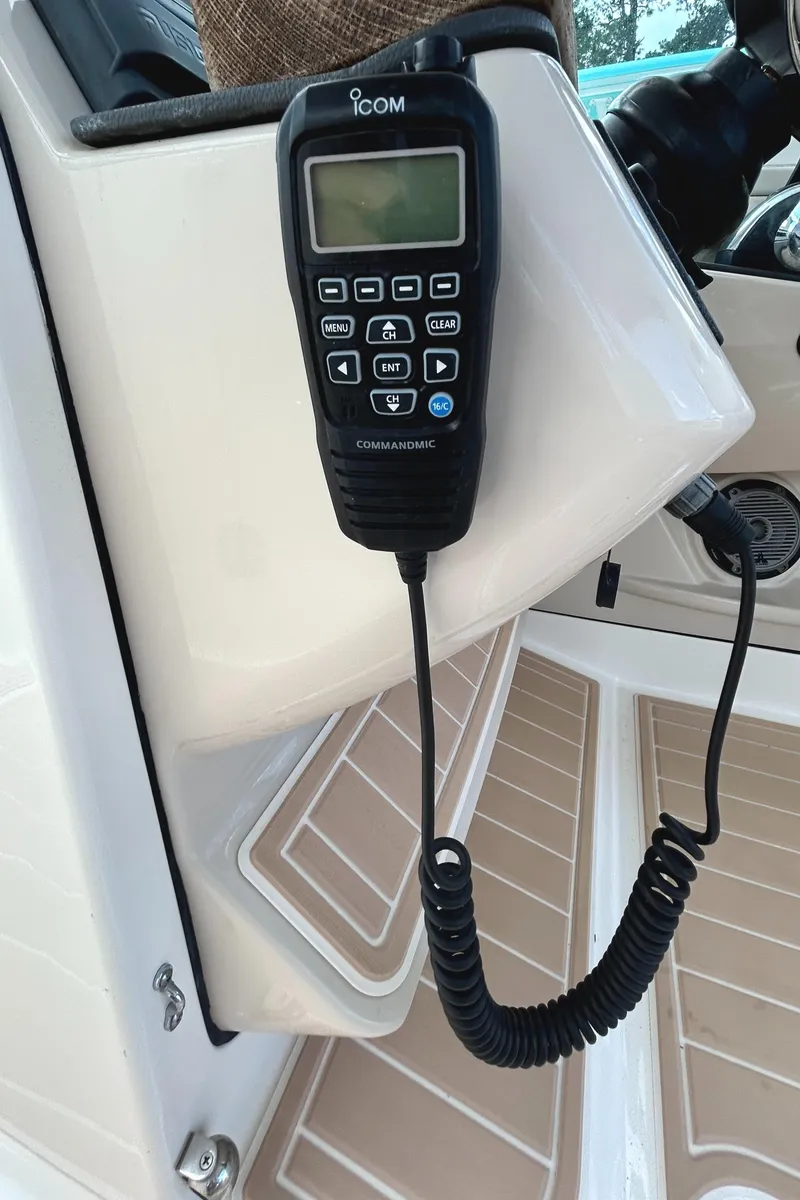 Slide: The Image of ICOM marine radio on 2017 Boston Whaler 320 Vantage boat dashboard. - 15