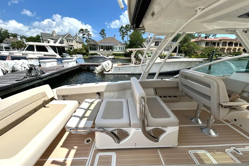 Slide: The Image of 2017 Boston Whaler 320 Vantage boat interior with seating, docked at marina. - 18