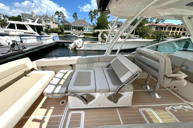 Slide: The Image of 2017 Boston Whaler 320 Vantage boat interior with seating, docked at marina. - 19