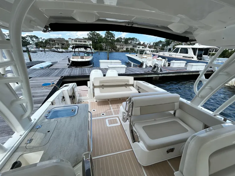 Slide: The Image of 2017 Boston Whaler 320 Vantage boat interior at marina, featuring spacious seating and modern design. - 21