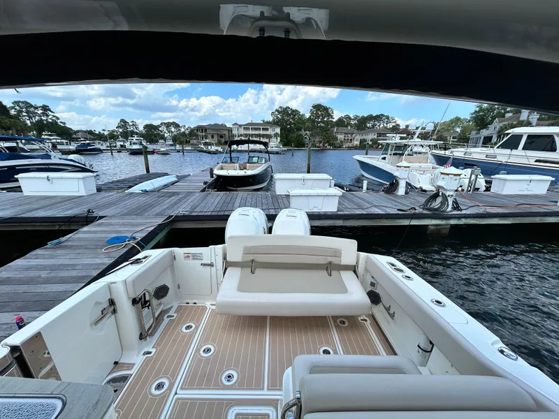 Slide: The Image of 2017 Boston Whaler 320 Vantage docked at a marina with scenic waterfront view. - 22