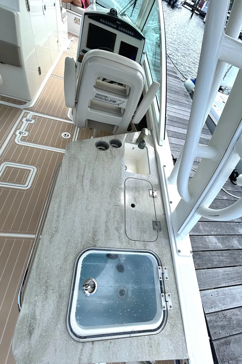 Slide: The Image of 2017 Boston Whaler 320 Vantage boat interior with sink and control panel. - 26