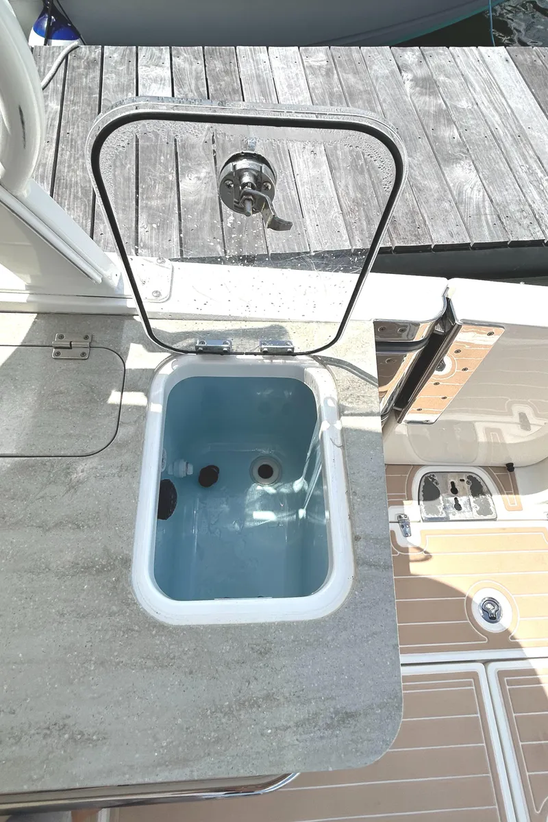 Slide: The Image of Boston Whaler 320 Vantage 2017 boat with open storage compartment on deck. - 27