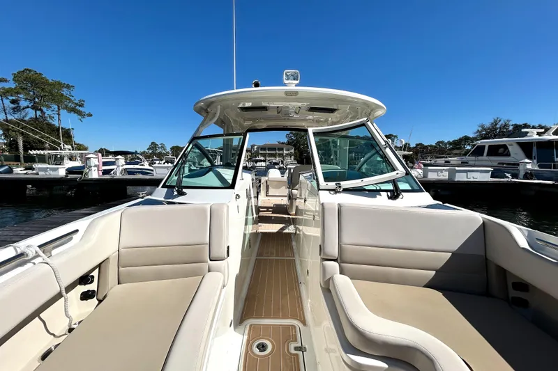 Slide: The Image of 2017 Boston Whaler 320 Vantage boat with spacious seating and sleek design in a marina. - 28