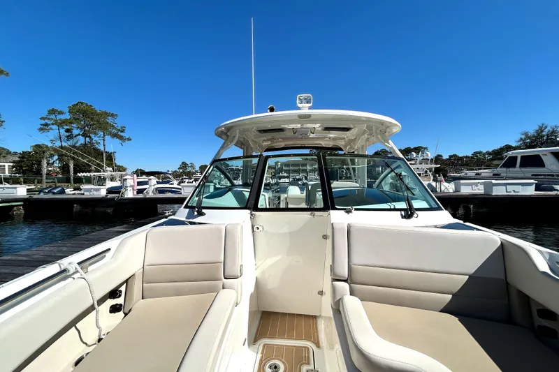Slide: The Image of 2017 Boston Whaler 320 Vantage boat docked at marina under clear blue sky. - 29