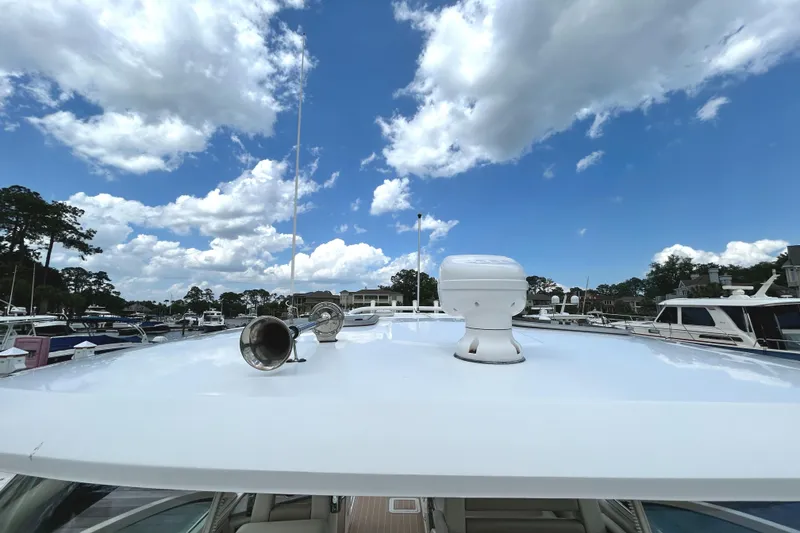 Slide: The Image of 2017 Boston Whaler 320 Vantage boat roof under a bright blue sky with clouds. - 31