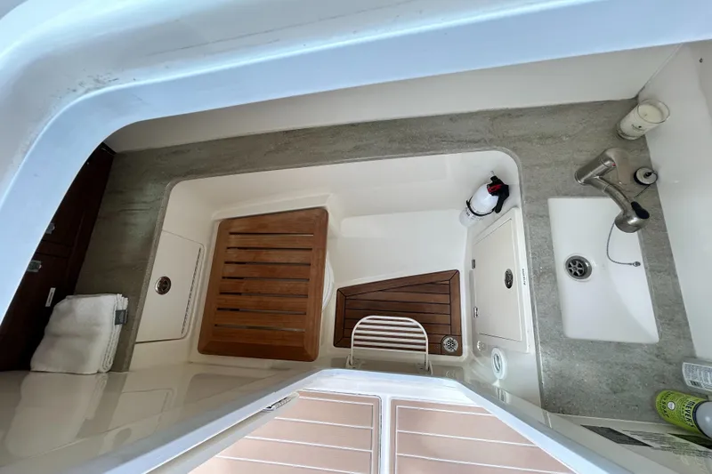 Slide: The Image of Interior view of 2017 Boston Whaler 320 Vantage boat, featuring sink and wooden flooring. - 32