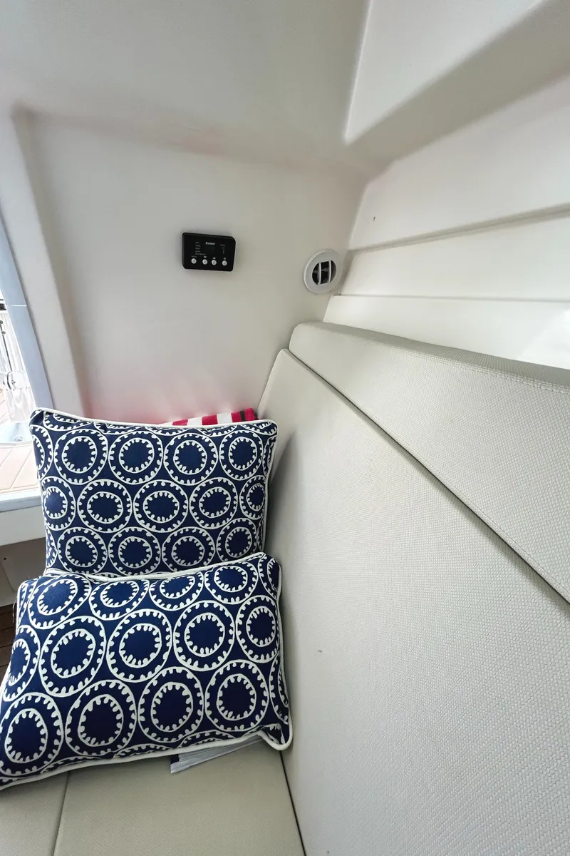 Slide: The Image of Interior of 2017 Boston Whaler 320 Vantage with patterned cushions and sleek design. - 35