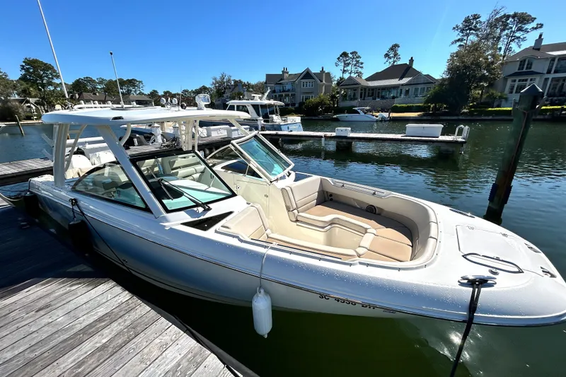 Slide: The Image of 2017 Boston Whaler 320 Vantage docked in a scenic marina setting. - 4