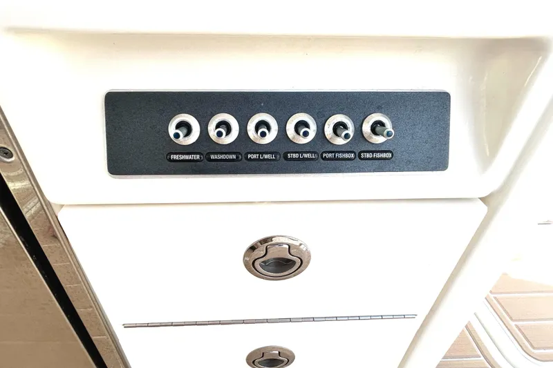 Slide: The Image of Control panel on 2017 Boston Whaler 320 Vantage boat, featuring labeled switches. - 42