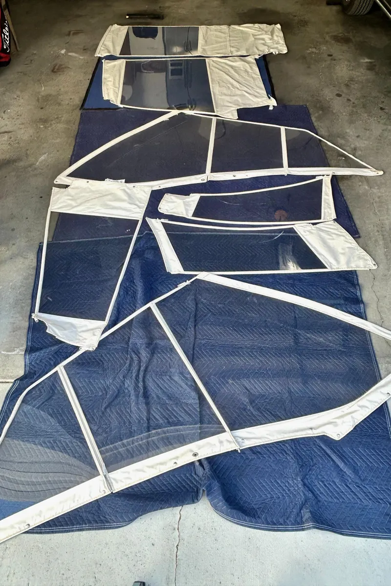 Slide: The Image of Boat canvas and windows for 2017 Boston Whaler 320 Vantage, laid out on a blue blanket. - 46