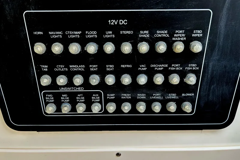 Slide: The Image of Control panel of a 2017 Boston Whaler 320 Vantage boat with labeled switches. - 48