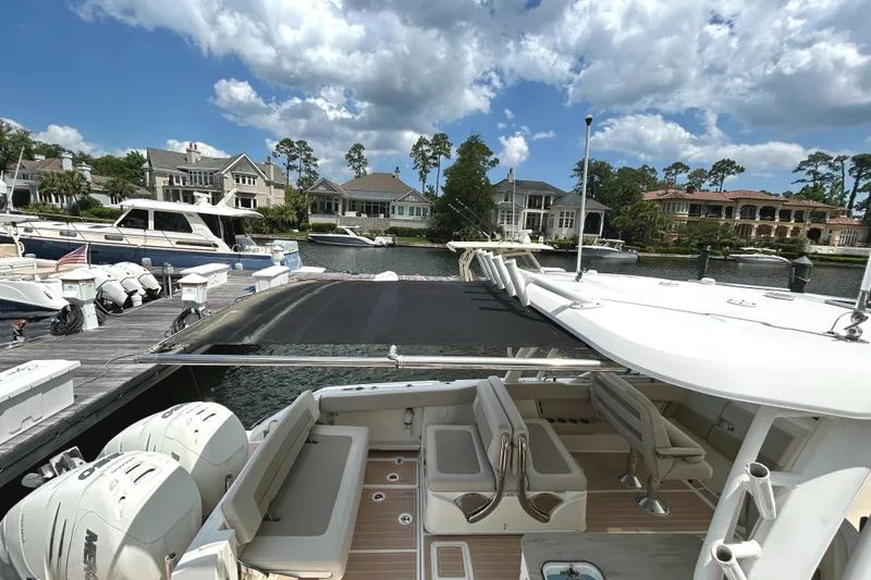 Slide: The Image of 2017 Boston Whaler 320 Vantage docked at marina, surrounded by luxury homes and boats. - 8