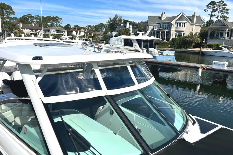 Slide: The Image of 2017 Boston Whaler 320 Vantage docked near waterfront homes. - 9