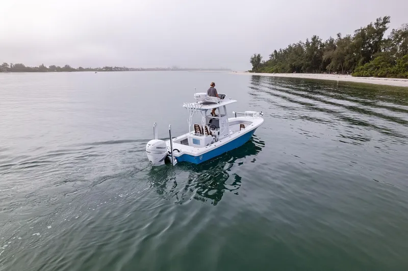 Slide: The Image of 2022 Barker Boatworks 26 Open cruising near a serene shoreline. - 10