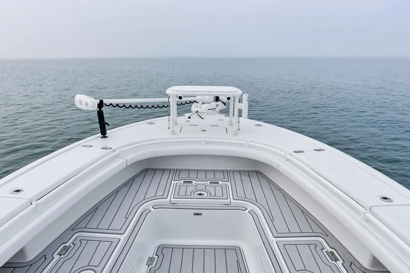Slide: The Image of 2022 Barker Boatworks 26 Open on calm sea, showcasing spacious deck and sleek design. - 11
