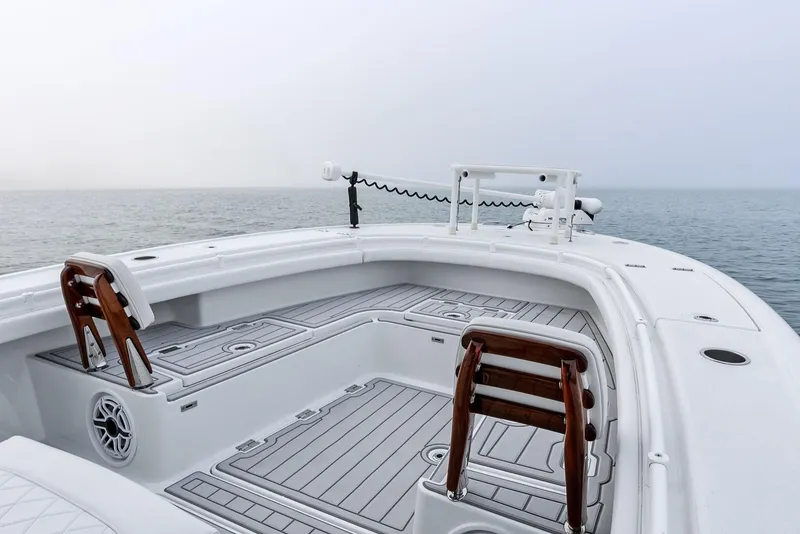 Slide: The Image of 2022 Barker Boatworks 26 Open on calm sea, featuring spacious deck and seating. - 14