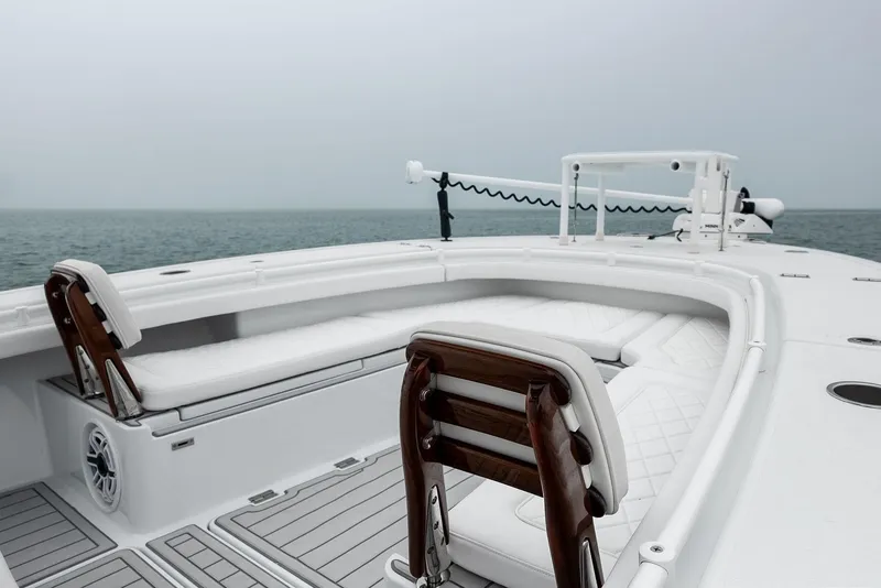 Slide: The Image of 2022 Barker Boatworks 26 Open, sleek design, spacious seating, ocean backdrop. - 15