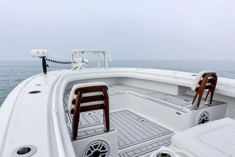 Slide: The Image of 2022 Barker Boatworks 26 Open on calm sea, featuring spacious deck and seating. - 16