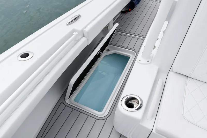 Slide: The Image of 2022 Barker Boatworks 26 Open, open storage compartment, sleek white interior design. - 19