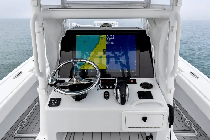 Slide: The Image of 2022 Barker Boatworks 26 Open helm with navigation display and steering wheel. - 20