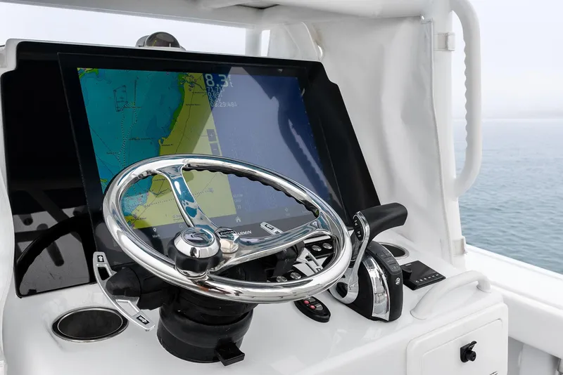 Slide: The Image of Steering console of 2022 Barker Boatworks 26 Open with navigation display. - 21