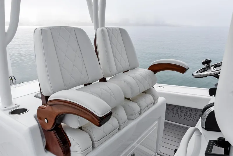 Slide: The Image of 2022 Barker Boatworks 26 Open, luxurious seating with ocean backdrop. - 24