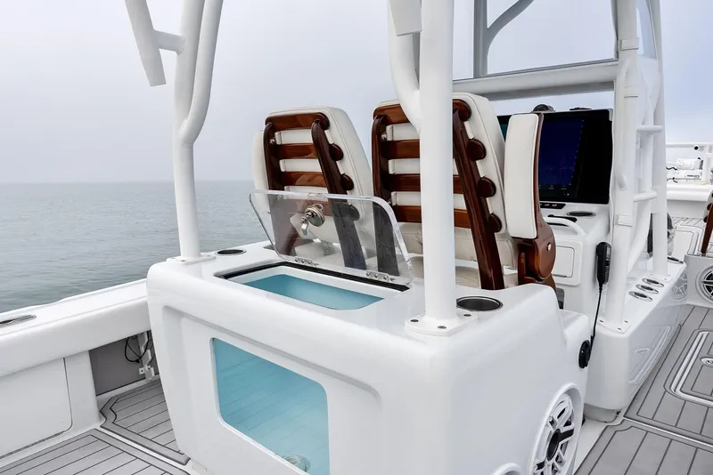 Slide: The Image of 2022 Barker Boatworks 26 Open interior with seating and storage, overlooking calm waters. - 26