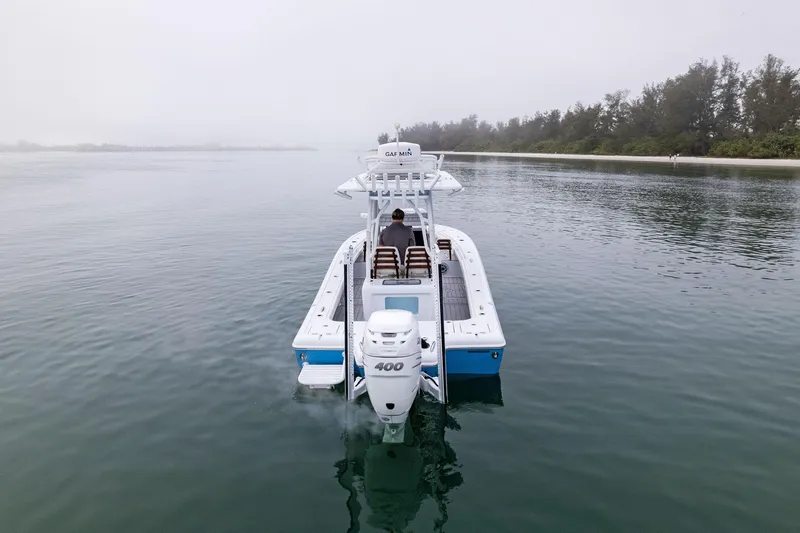 Slide: The Image of 2022 Barker Boatworks 26 Open on calm water, rear view with outboard motor. - 3