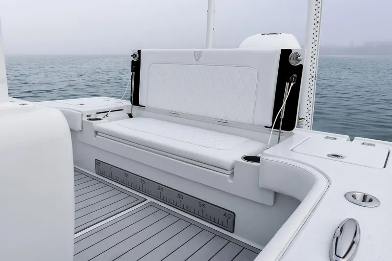 Slide: The Image of 2022 Barker Boatworks 26 Open, featuring sleek white seating and deck, on calm waters. - 31