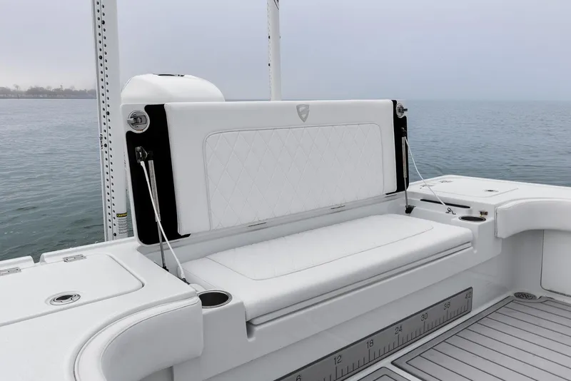 Slide: The Image of 2022 Barker Boatworks 26 Open, featuring sleek white seating on calm waters. - 32