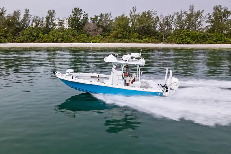 Slide: The Image of 2022 Barker Boatworks 26 Open cruising on calm water near a forested shoreline. - 35