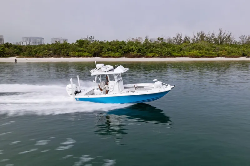 Slide: The Image of 2022 Barker Boatworks 26 Open cruising on calm water near a lush shoreline. - 36