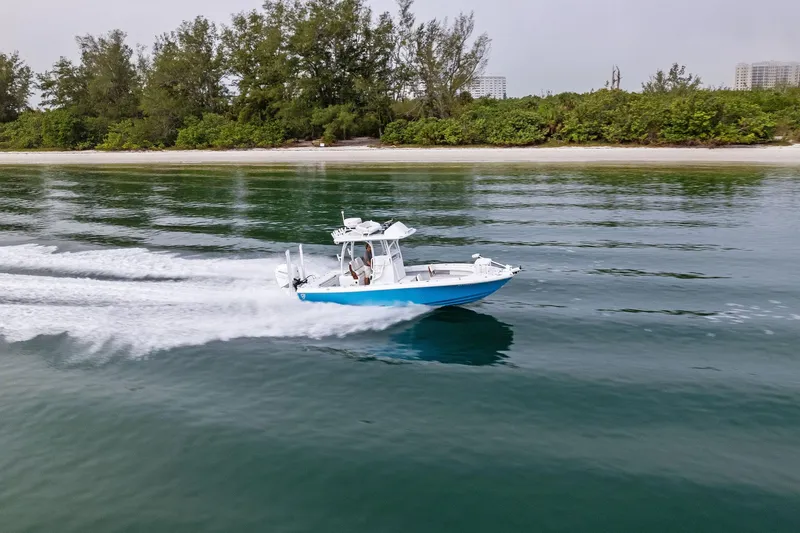 Slide: The Image of 2022 Barker Boatworks 26 Open cruising near a lush shoreline. - 37